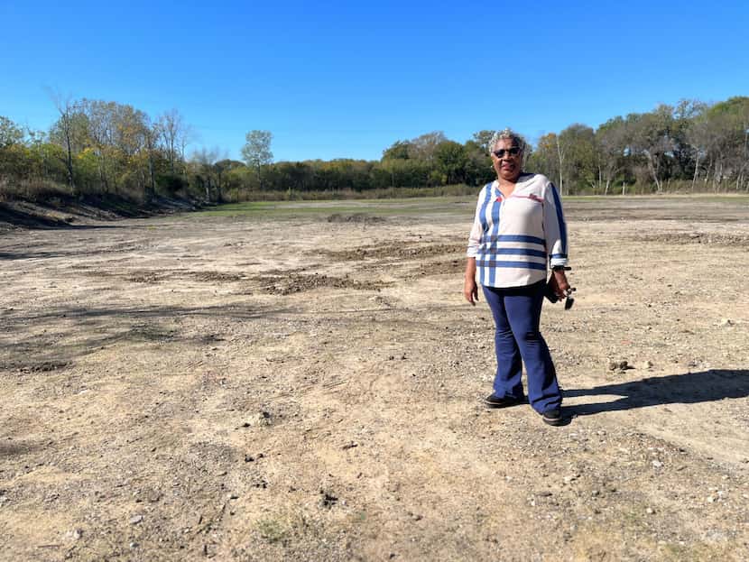 South Dallas resident and local environmental activist Marsha Jackson stands on the ground...