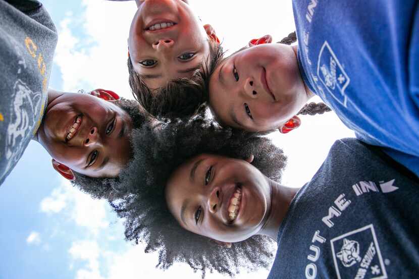 Kids in a circle, looking down at the camera