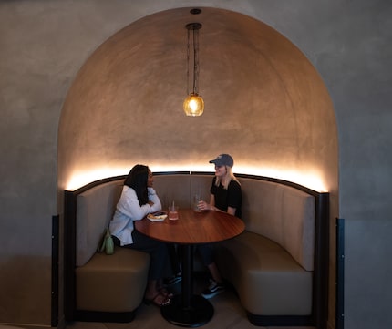 Bianca Amasha, left, and Chloe Bohannon, sit in a new seating inlet upstairs at Seis...