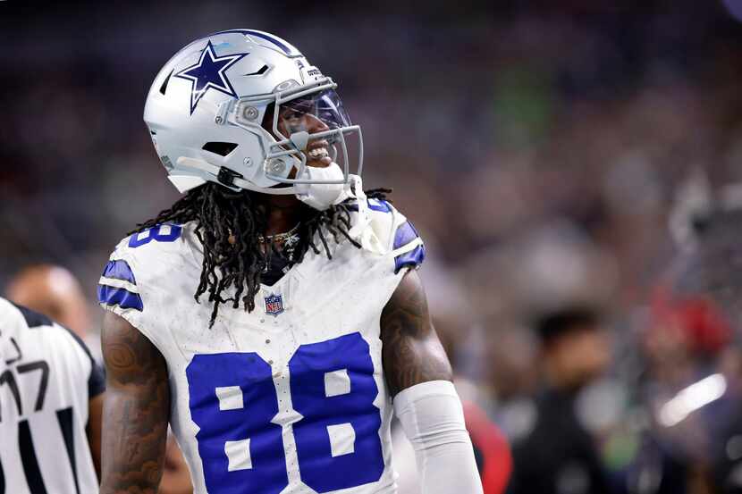 Dallas Cowboys wide receiver CeeDee Lamb (88) smiles toward the crowd after picking up a...