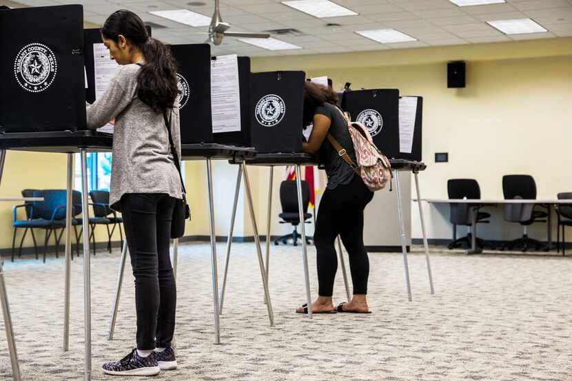 Zuleima Martinez, left, and Sananda McCall, both of Arlington, Texas cast their vote on...