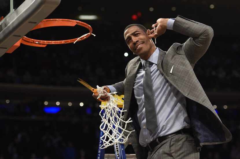 Mar 30, 2014; New York, NY, USA; Connecticut Huskies head coach Kevin Ollie celebrates after...