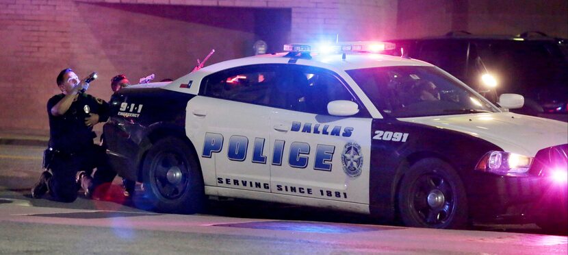 07/07/16 - Pinned down behind a police cruiser that was hit by gunfire, Dallas police...