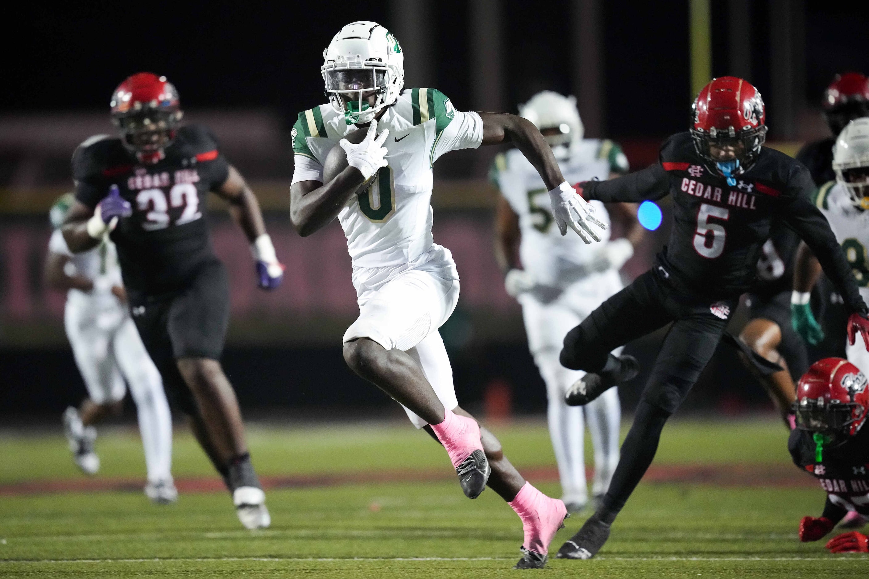 DeSoto running back Myson Cook-Johnson (0) gets past Cedar Hill defensive backs Avondric...