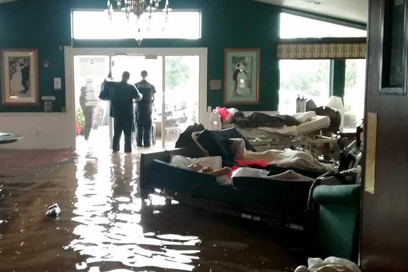Residents lay on sofas waiting to be evacuated from the Cypress Glen senior care facility in...