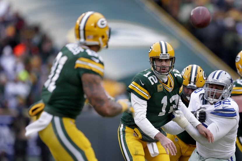 Green Bay Packers quarterback Aaron Rodgers (12) throws a fourth quarter shuffle pass to...