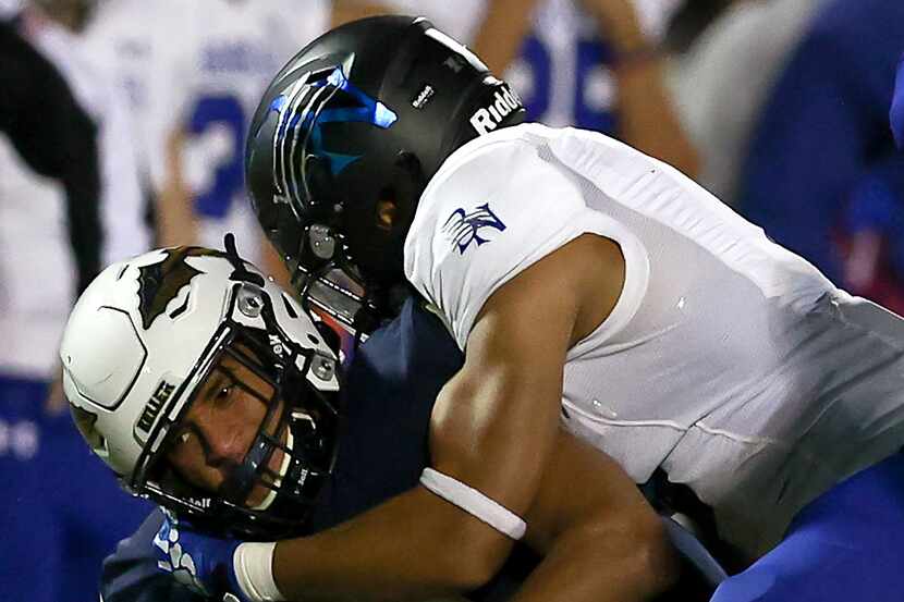 Keller wide receiver Amarion Henry (L) is brought down by Byron Nelson linebacker Ashton...