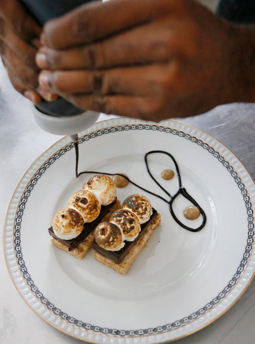 
 Pastry intern Salifu Mansaray prepares S'more at Café Momentum during his Friday evening...