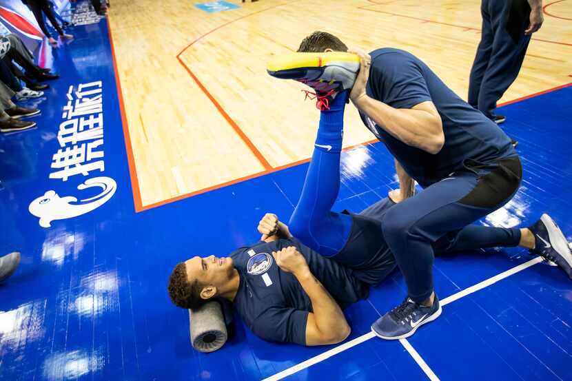 Dallas Mavericks forward Dwight Powell stretches before an NBA China Games 2018 preseason...