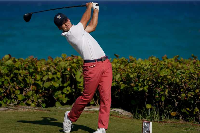 Pierceson Coody, of the USA team, watches his tee shot on the 14th hole in the singles...