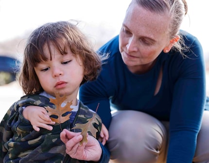 Christina Cabral-Arredondo, 45, offers a leaf to her son Nicholas Arredondo, 5, following a...