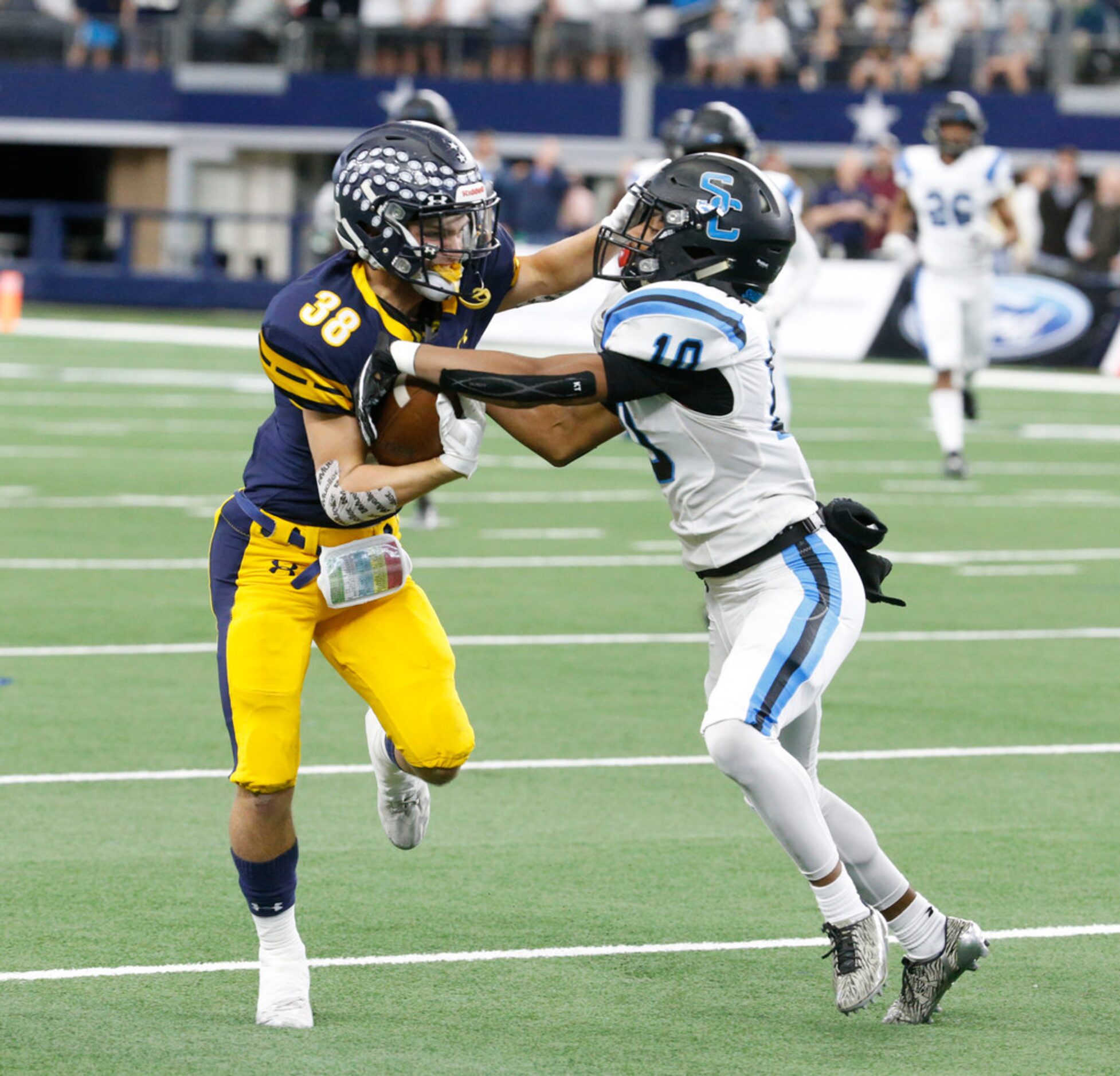 Highland Park's  Sam Parker (38) stiff arms Shadow Creek's Greg Hancock during the first...