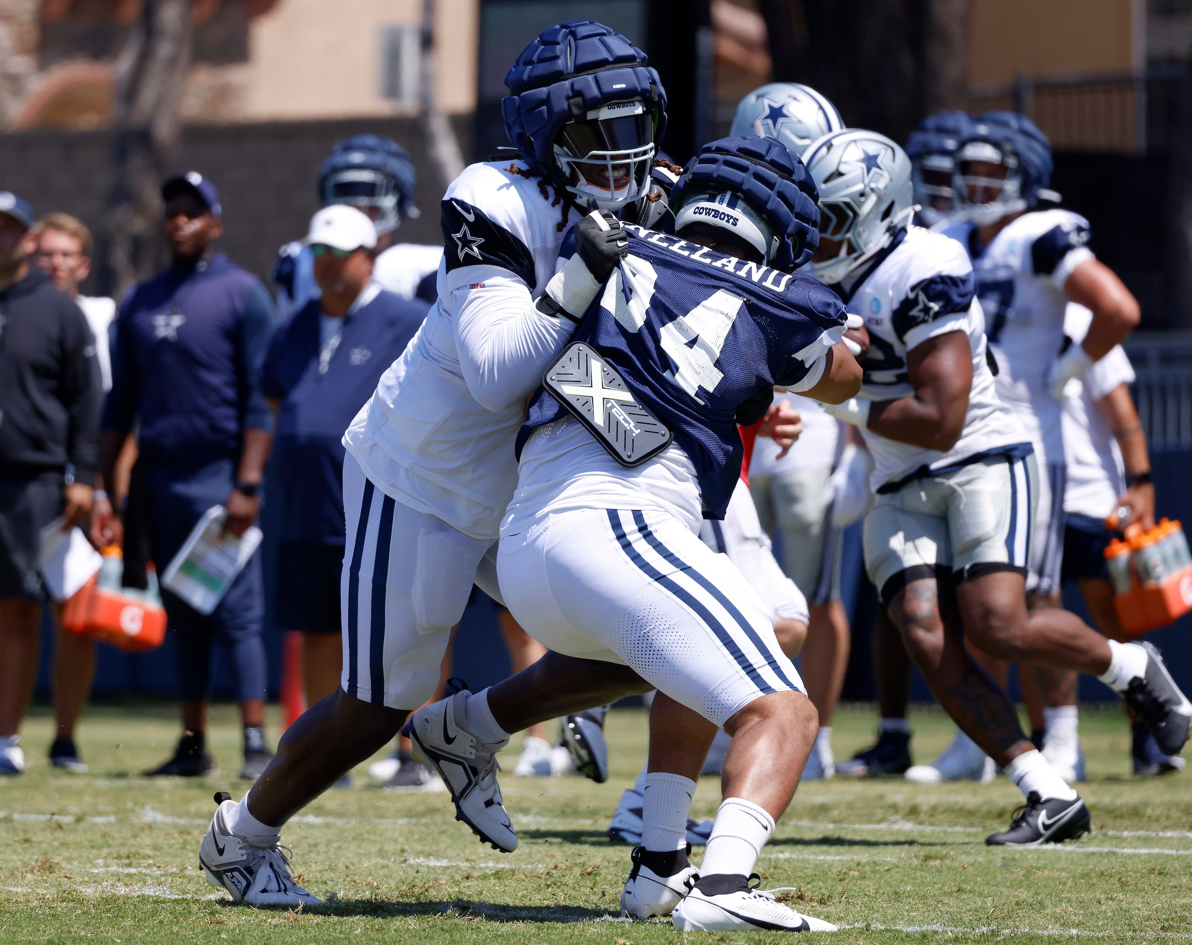 Dallas Cowboys tackle Tyler Guyton (60) blocks defensive end Marshawn Kneeland (94) during a...