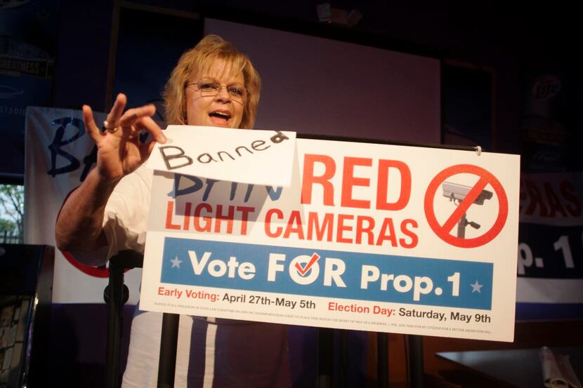 
Arlington petition drive leader Kelly Canon taped an update to a “Ban Red Light Cameras”...