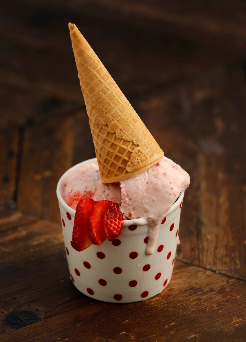Fresh strawberry thyme ice cream with a waffle cone 