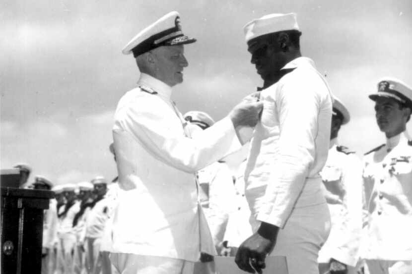 Admiral Chester Nimitz, the Commander in Chief, Pacific Fleet, pins Navy Cross on Doris...