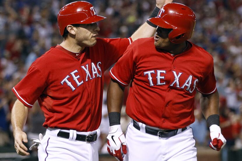 Texas Rangers' Adrian Beltre, right, is congratulated by Ian Kinsler after his two-run home...