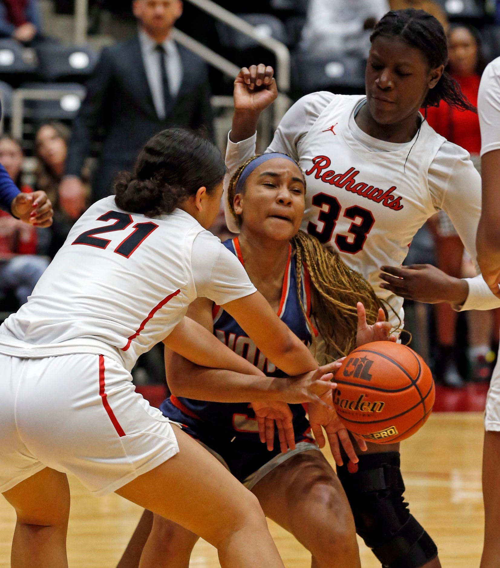 McKinney North high's G Kai Hall (3) is buried in the defense of Frisco Liberty High’s G...