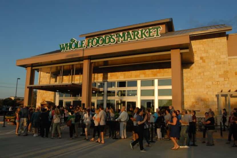 
Highland Village Whole Foods customers line up outside the first Denton County store on...