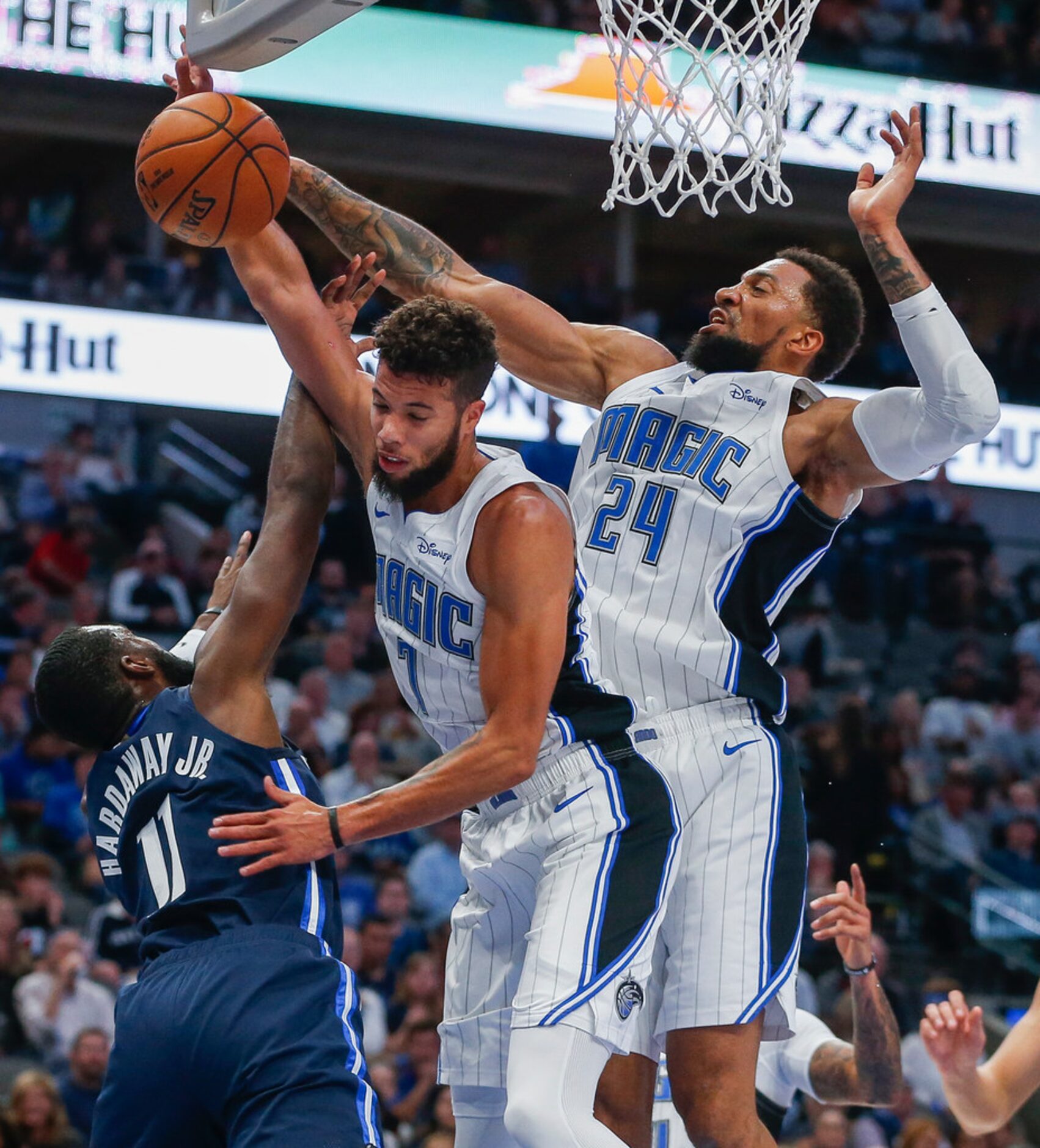 A shot by Dallas Mavericks guard Tim Hardaway Jr. (11) is blocked by Orlando Magic guard...