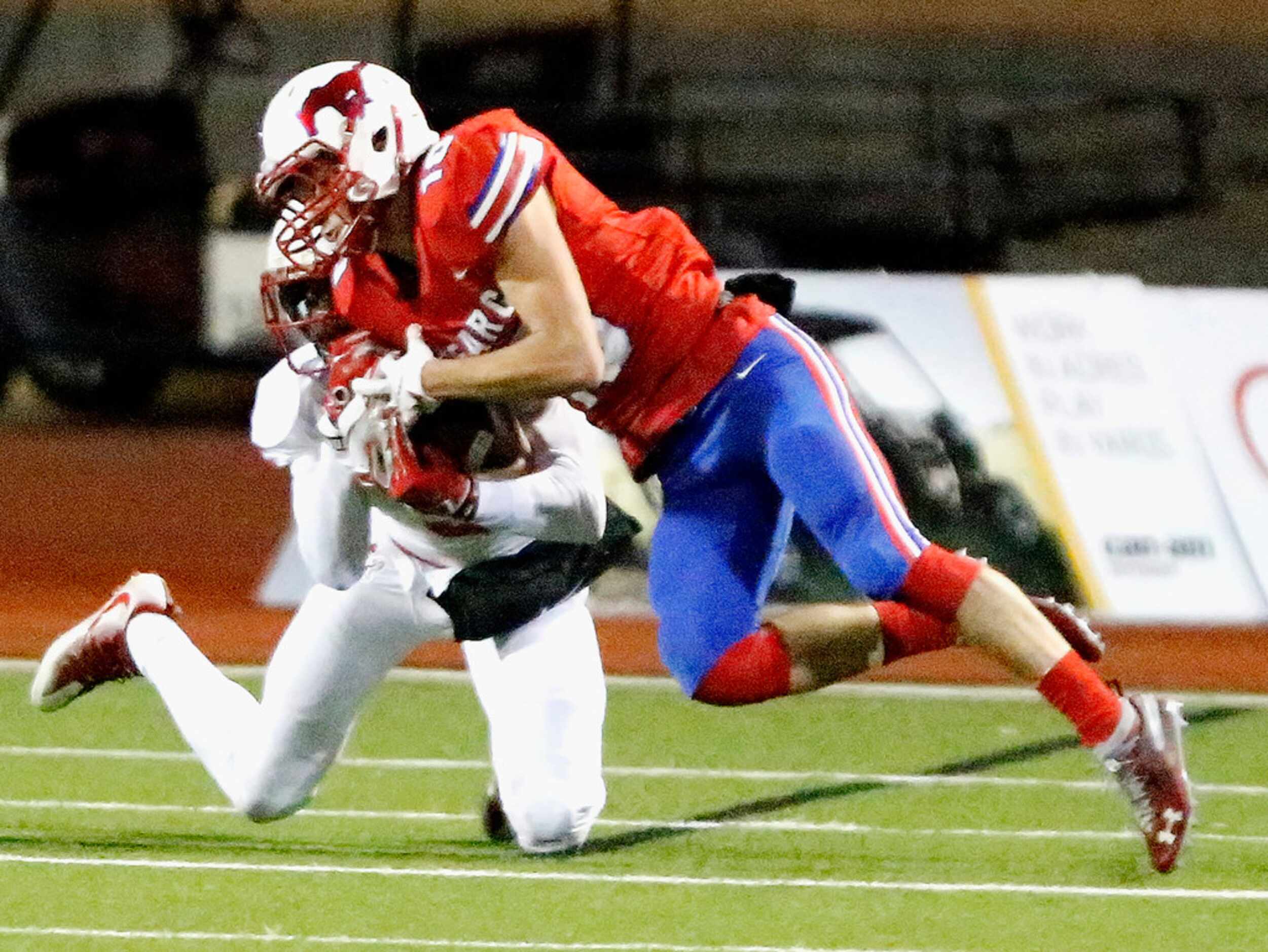 J.J. Pearce High School wide receiver Zack Brickert (10) makes a catch while defended by...