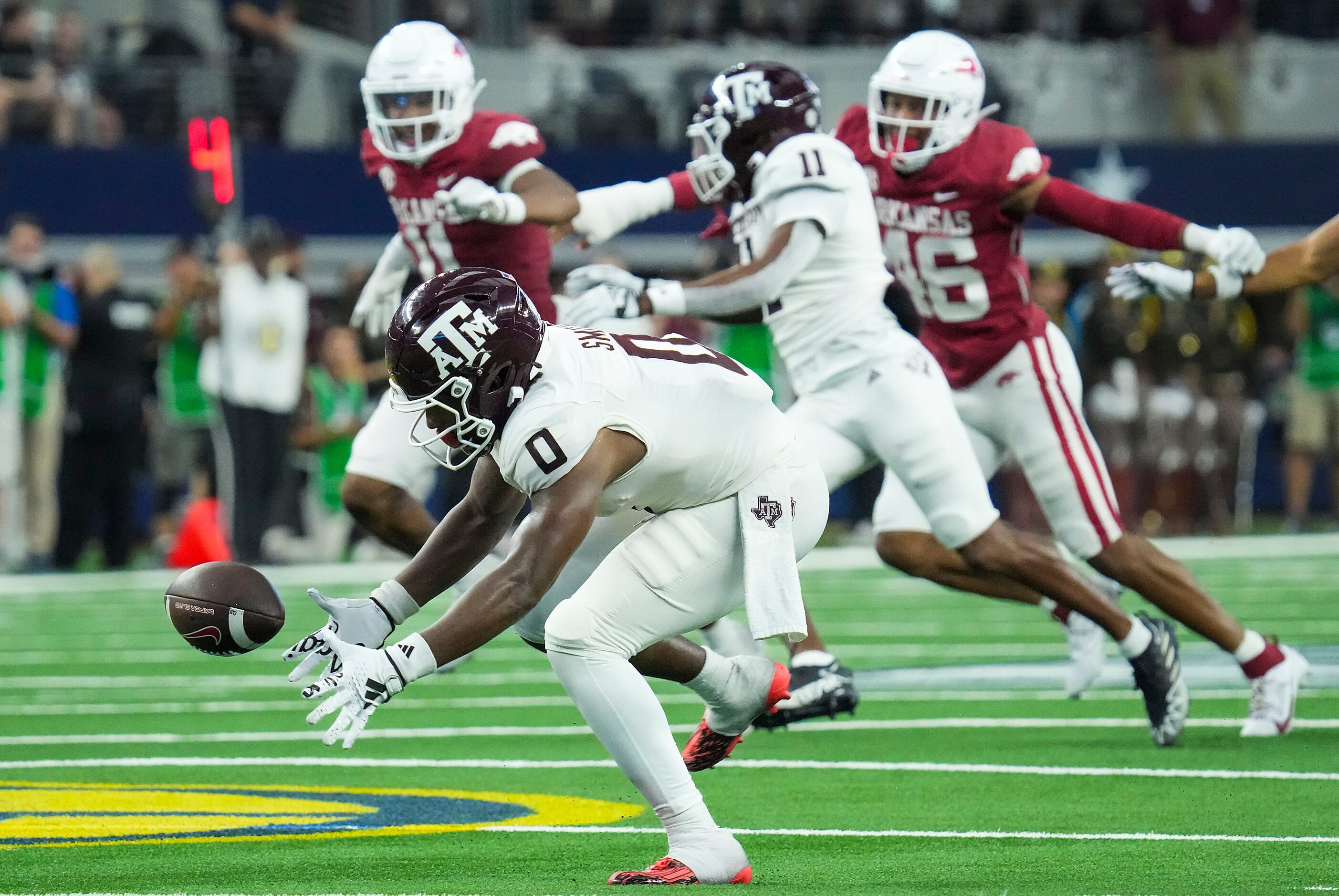 Texas A&M’s Ainias Smith (0) recovers his own fumble before returning punt 82-yards for a...