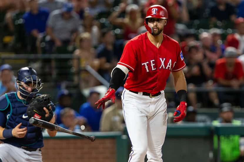 Texas Rangers' Joey Gallo drops his bat after drawing a walk during the seventh inning of a...