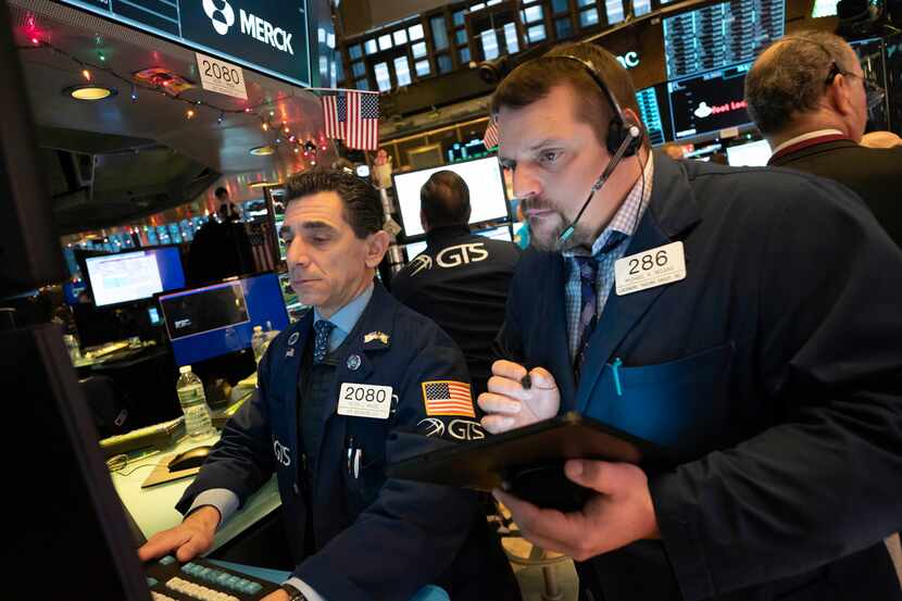 Traders monitor stock prices at the New York Stock Exchange on Thursday. Global shares rose...