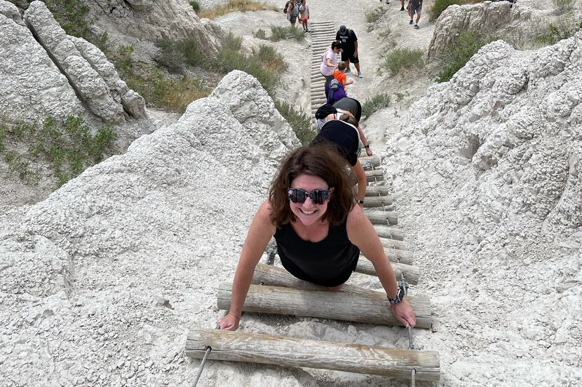 Tyra climbs down a 50-foot ladder along the Notch Trail in Badlands National Park.