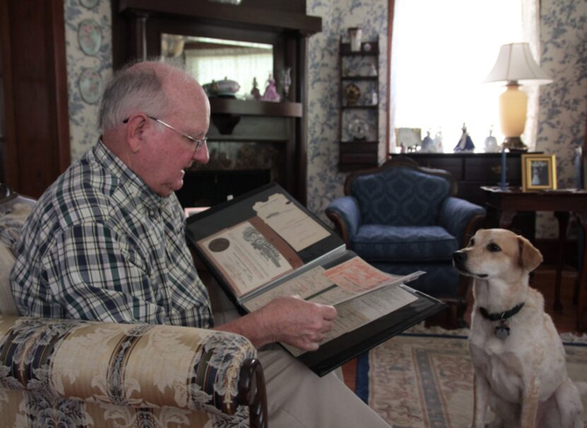 Harold Green looks at the original deed of the Munger Place home he and his wife, Gale, have...