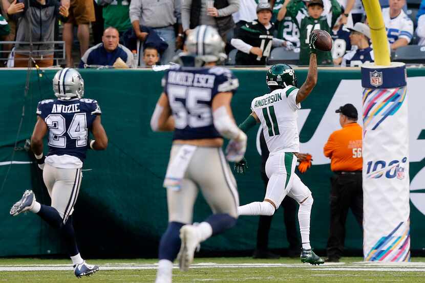 Jets wide receiver Robby Anderson (11) scores a 92-yard touchdown as he's chased by Cowboys...