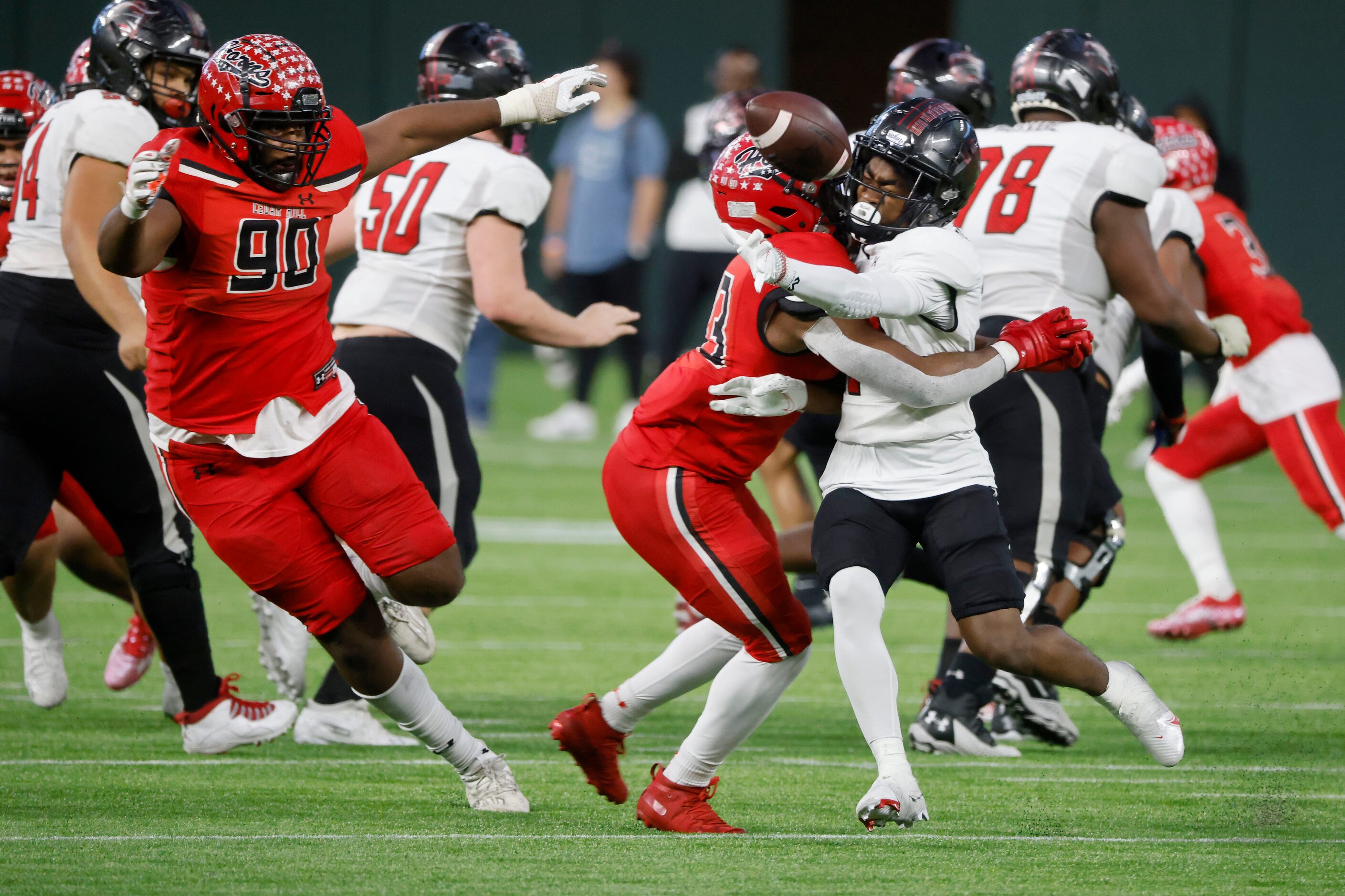 Cedar Hill defenders Syncere Massey (90) and Traviun Smith (33) defend a shovel pass by...