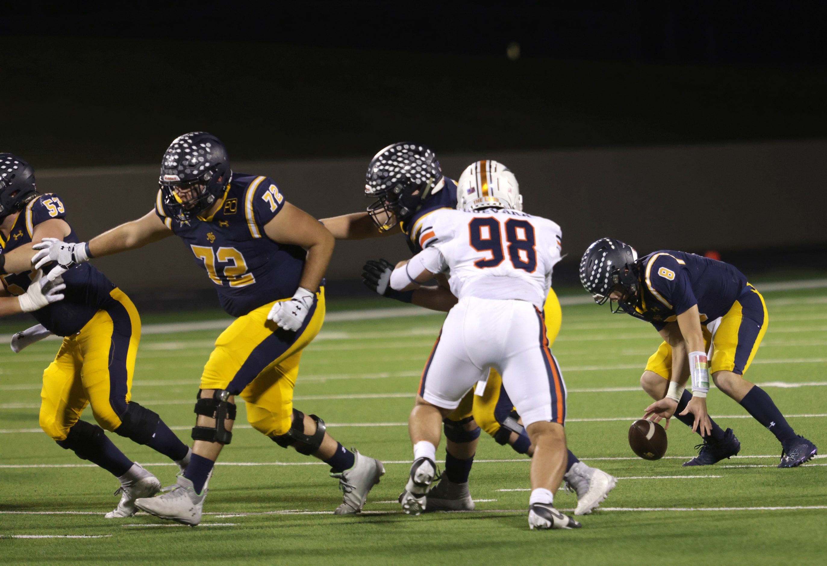 Highland Park's Buck Randall gains control of a loose snap in a high school football playoff...