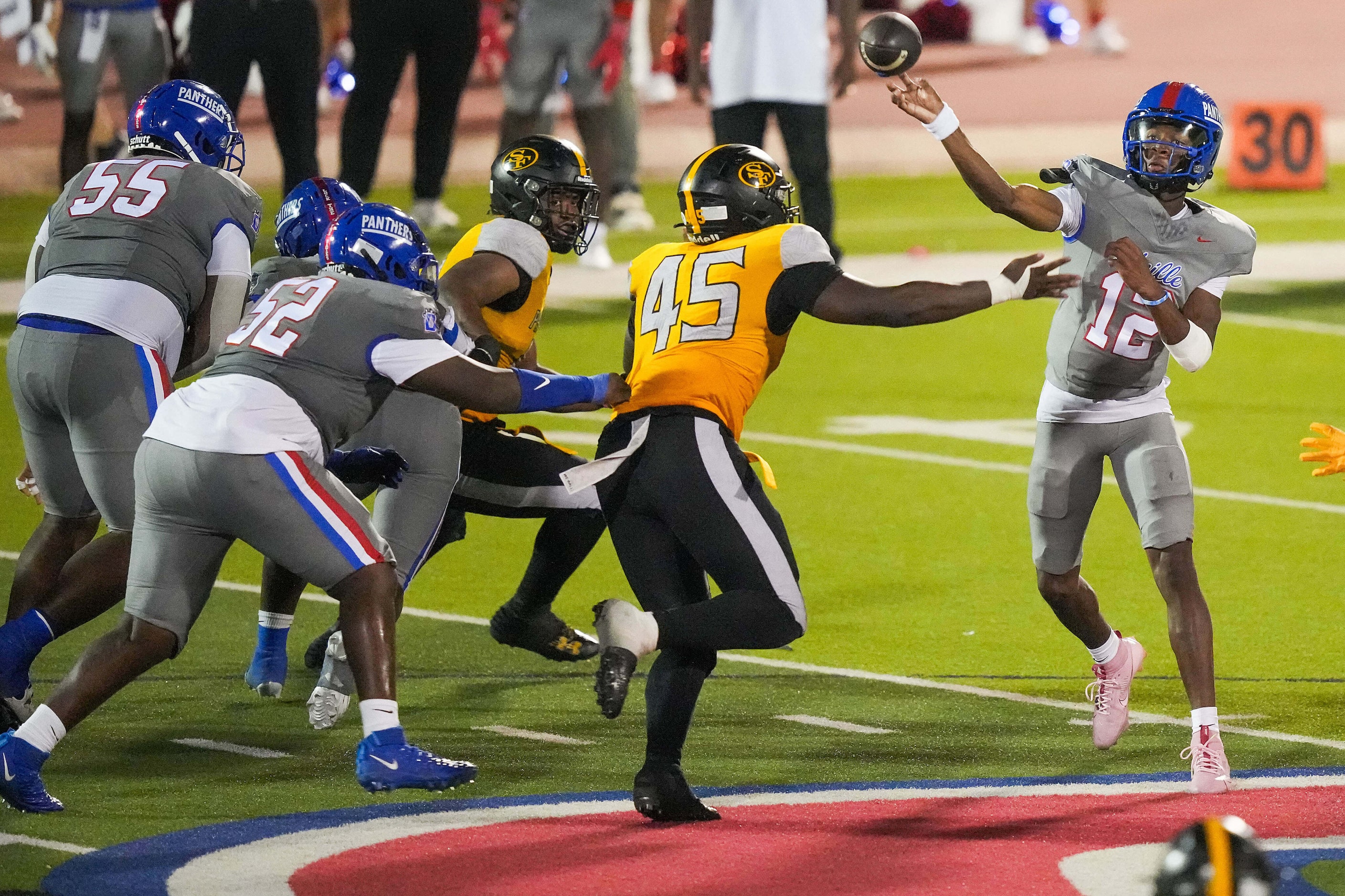 Duncanville quarterback Keelon Russell (12) throws a pass under pressure from St. Frances...