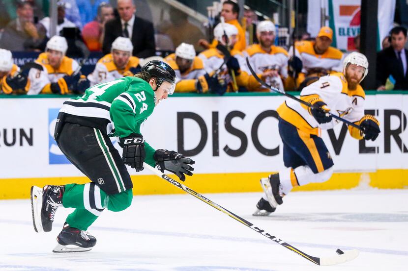 Dallas Stars left wing Roope Hintz (24) drives the puck up the ice as he is defended by...