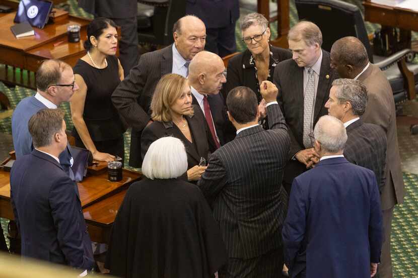 Texas Senators huddle after the defense team rested their case during day 8 of Texas...