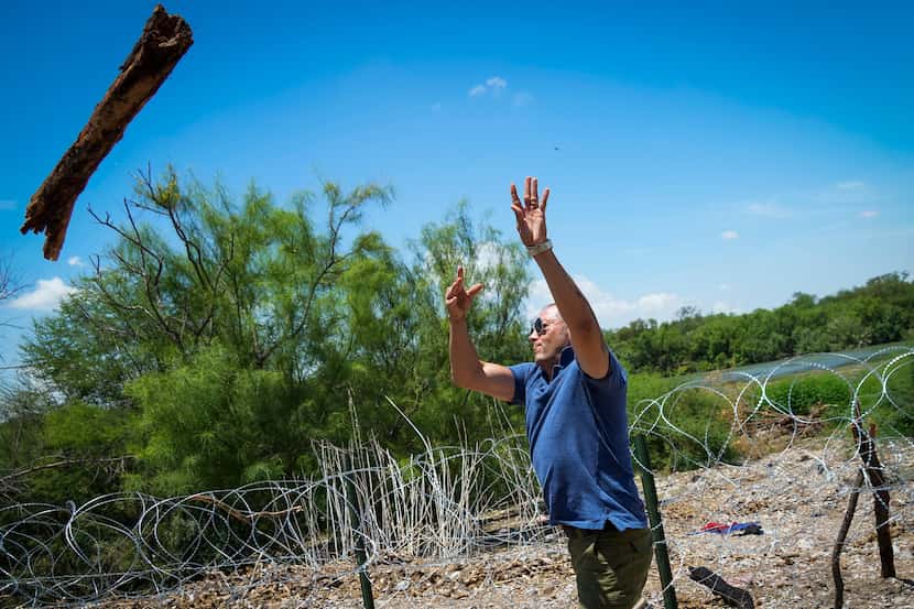Poncho Nevárez tossed away a log that migrants had used to prop up a stretch of concertina...