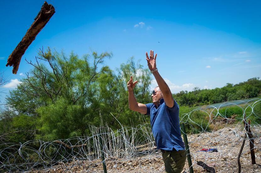 Poncho Nevárez tossed away a log that migrants had used to prop up a stretch of concertina...