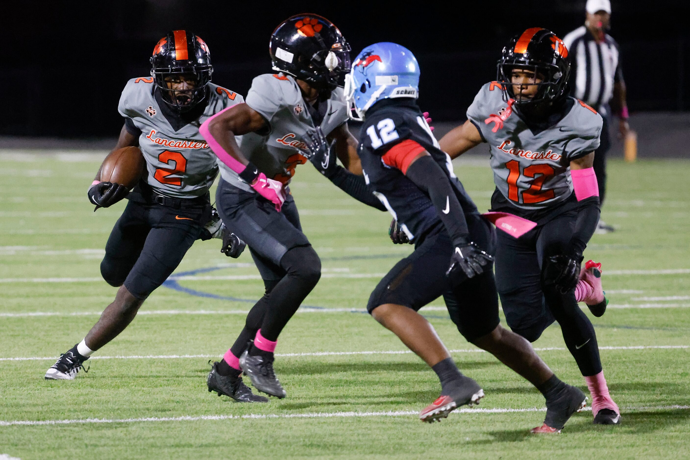 Lancaster High’s Izayah Lee (2) runs the ball for a yardage during the second half of a...