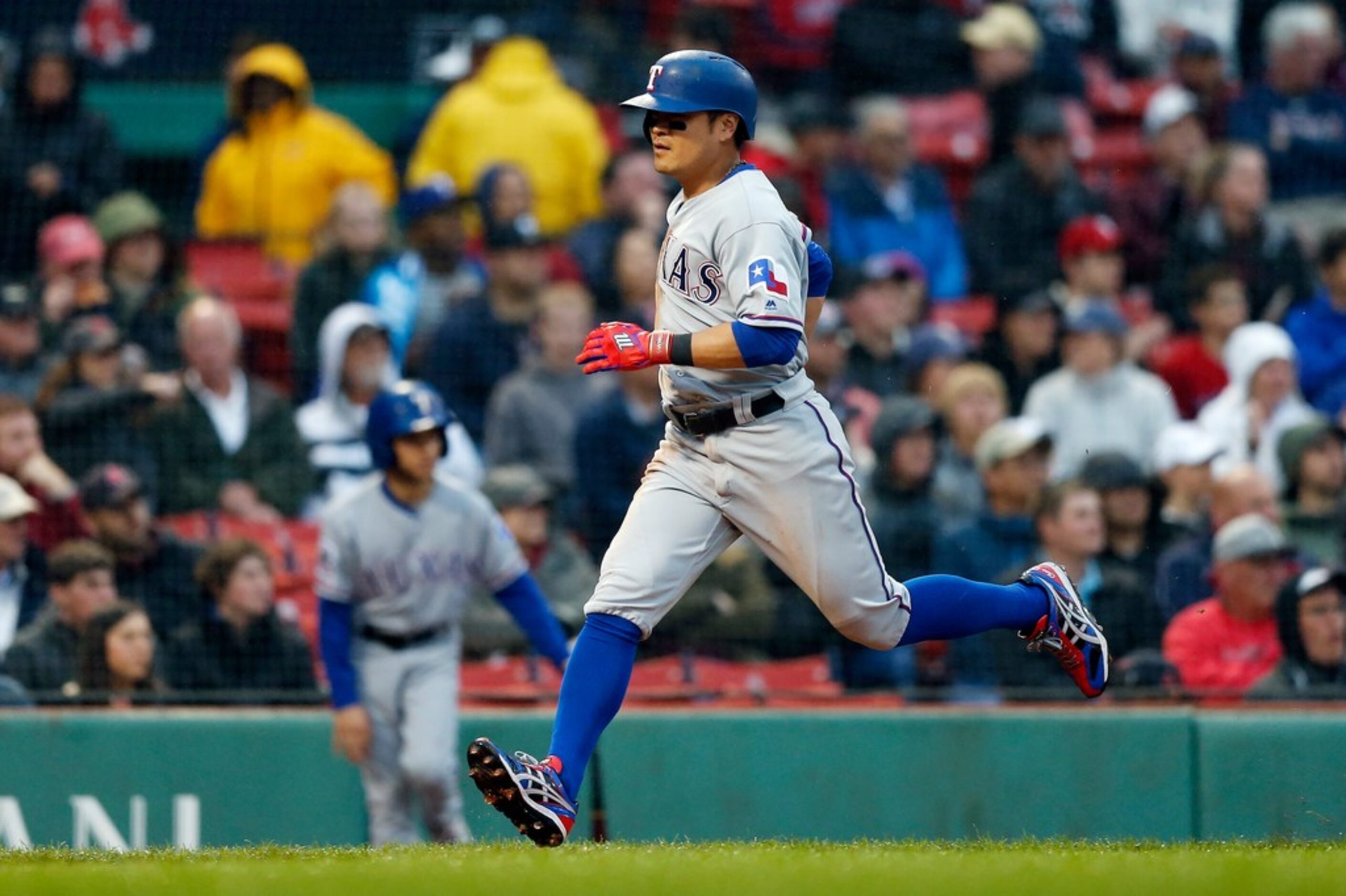 Texas Rangers' Shin-Soo Choo scores on a single by Elvis Andrus during the first inning of a...