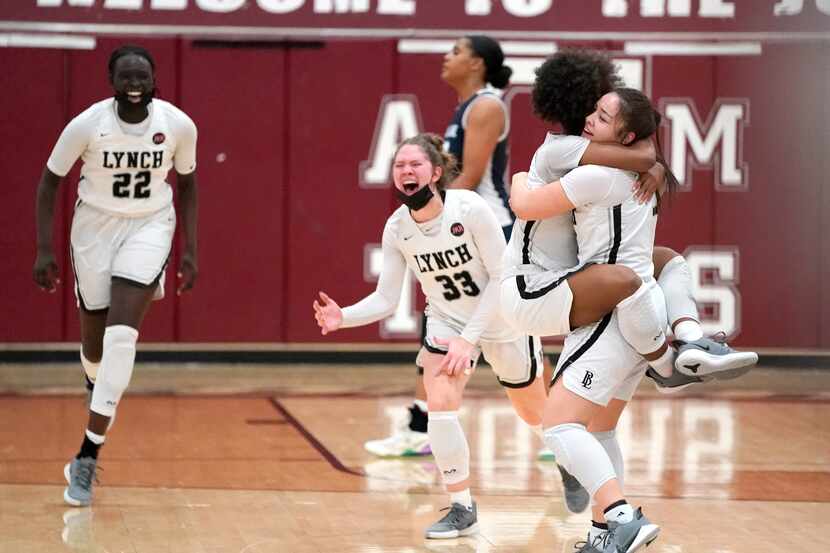 Dallas Bishop Lynch’s Madison Cockrell (5) jumps into the arms of Talia Depetrillo (11)...