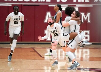 Dallas Bishop Lynch’s Madison Cockrell (5) jumps into the arms of Talia Depetrillo (11)...