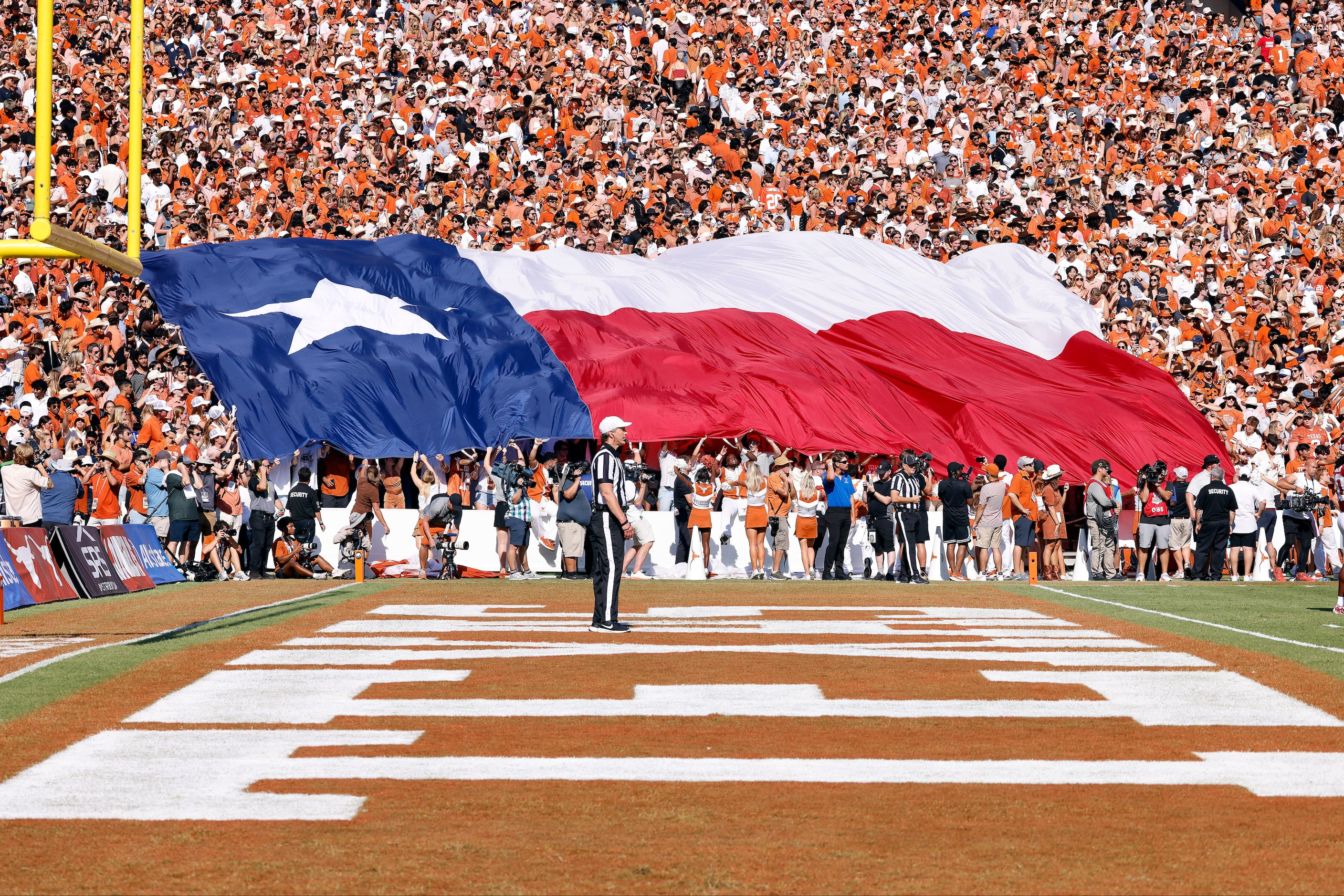 The Texas flag is handed down the stands by the Texas Longhorns students during the Red...