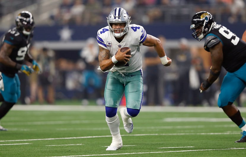 Dallas Cowboys quarterback Dak Prescott (4) rushes up the field in a game against the...