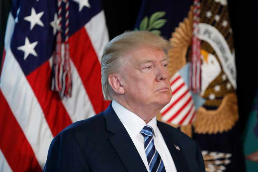 President Donald Trump listens as Treasury Secretary Steve Mnuchin speaks at the Treasury...