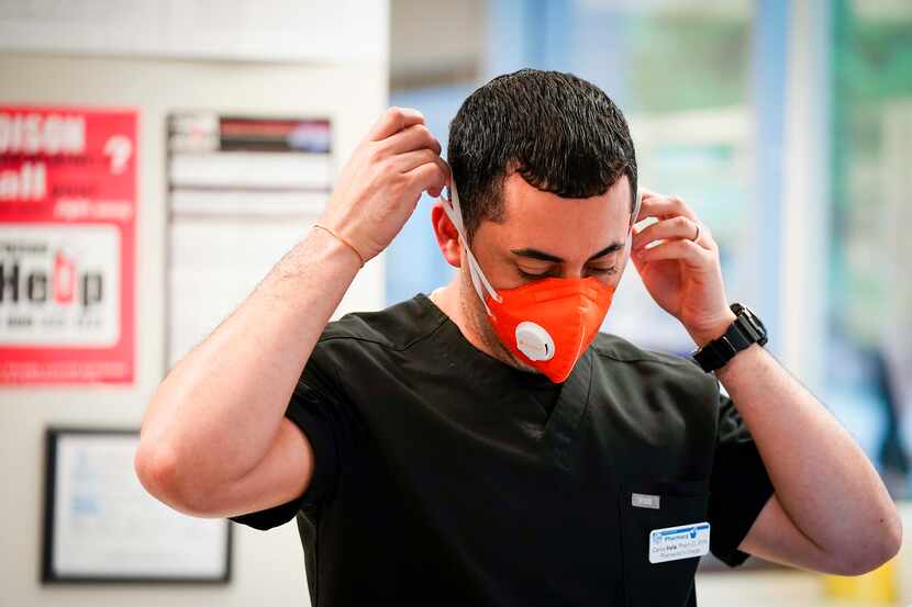 Pharmacist Carlos Irula donned a face mask while working at St. Vincent de Paul Pharmacy at...