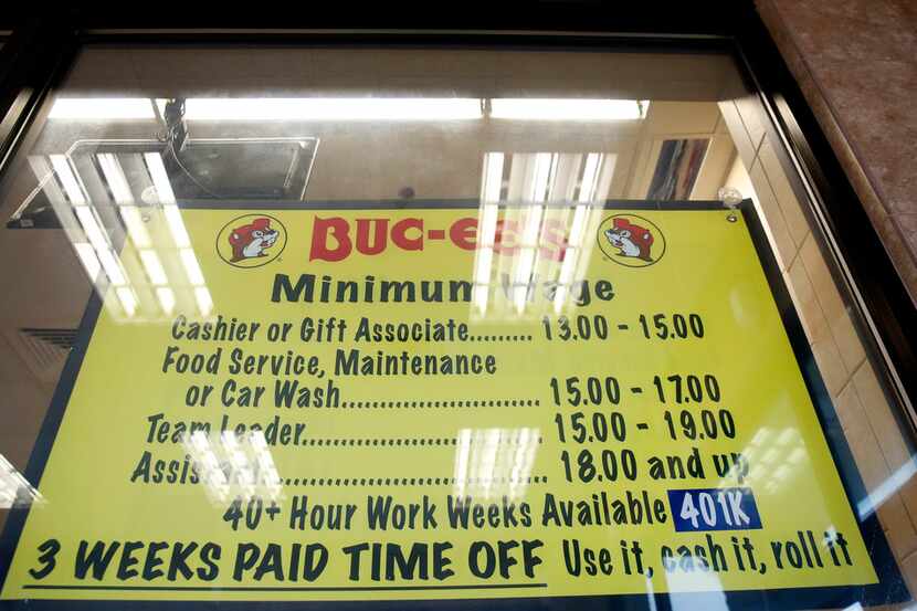 A sign shows the salary and benefits for employees at Buc-ee's in Madisonville, Texas on...