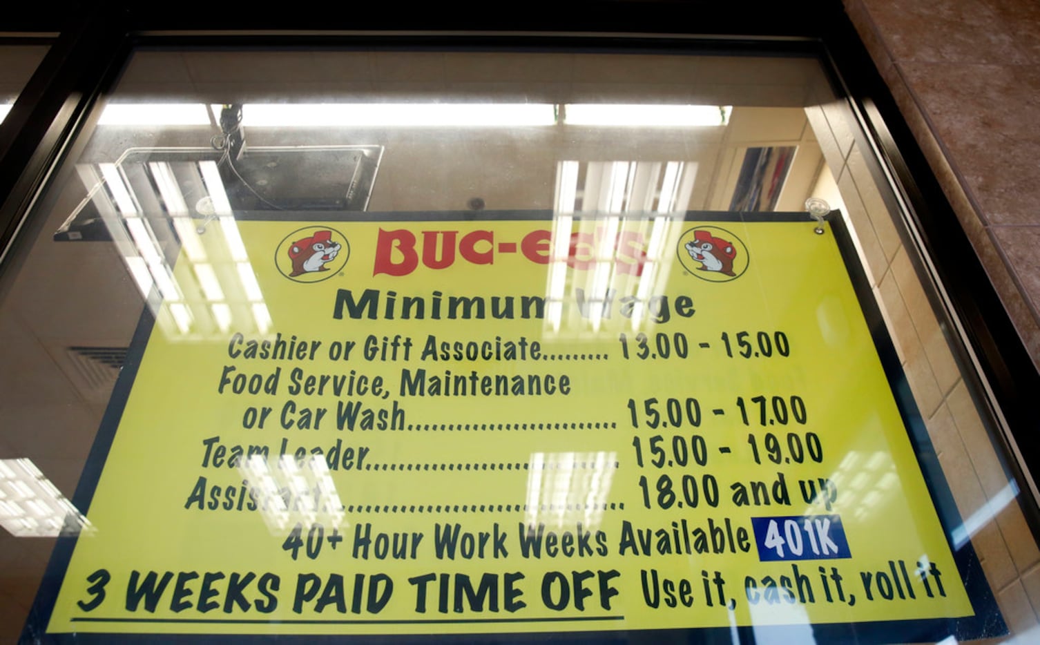 A sign shows the salary and benefits for employees at Buc-ee's in Madisonville, Texas on...