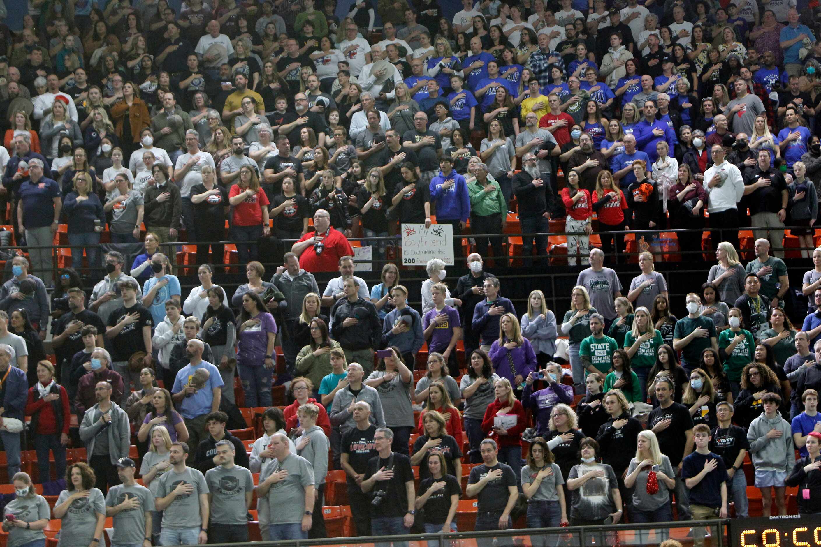 A capacity crowd pauses for the national anthem prior to the start of 5A competition. The...