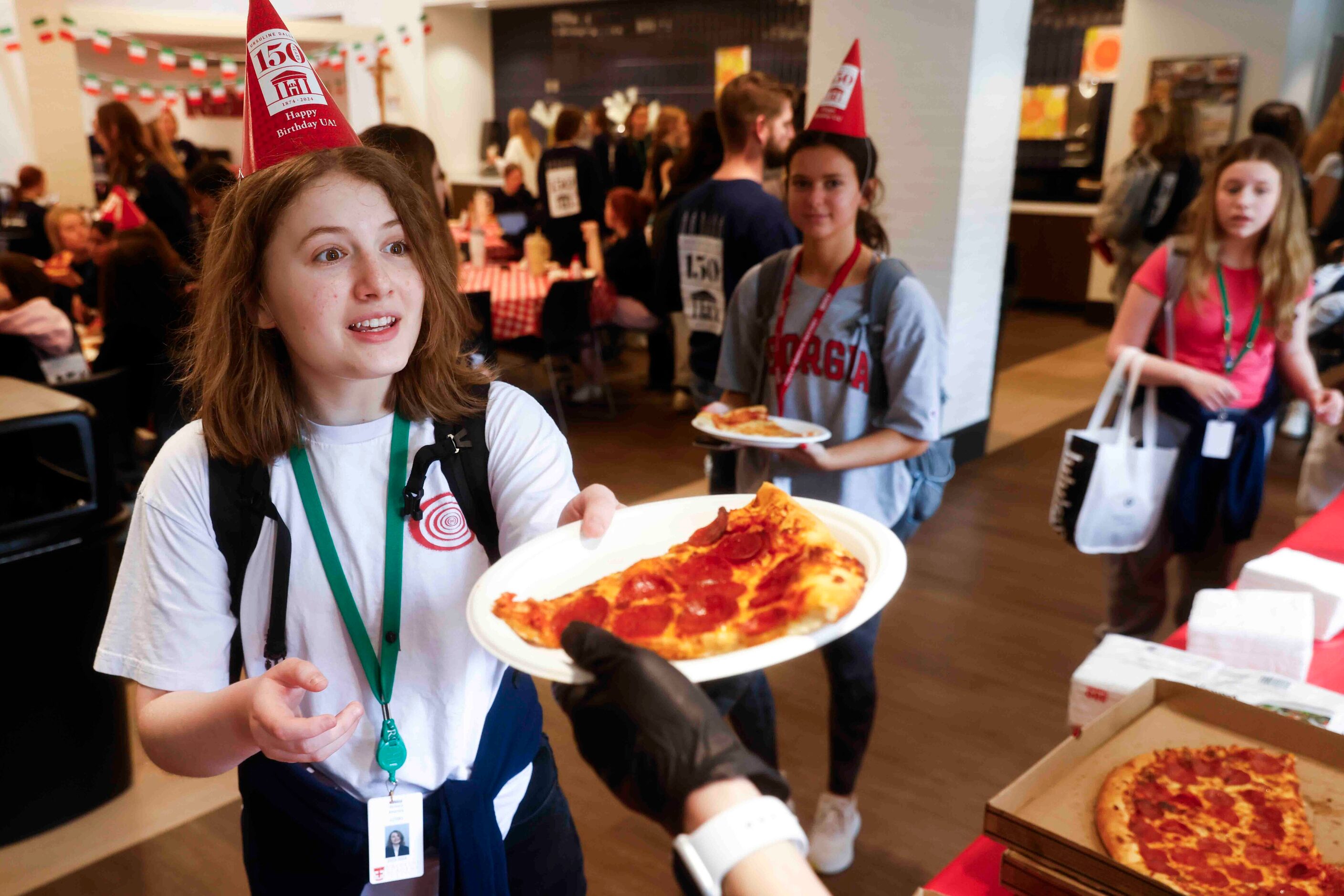 Student Victoria Kearney reacts while getting her pizza for lunch during the 150th...